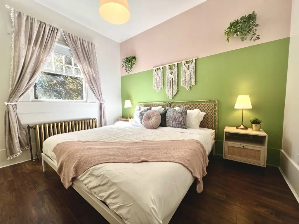 Soft sunlight and soothing tones create a peaceful retreat in this beautifully designed bedroom. Guests can unwind in modern comfort surrounded by warm textures, cozy linens, and touches of natural greenery — a restful escape during their Vancouver stay.