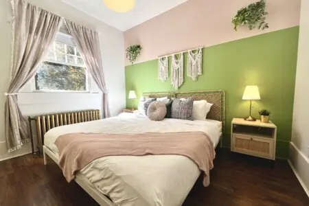 Soft sunlight and soothing tones create a peaceful retreat in this beautifully designed bedroom. Guests can unwind in modern comfort surrounded by warm textures, cozy linens, and touches of natural greenery — a restful escape during their Vancouver stay.