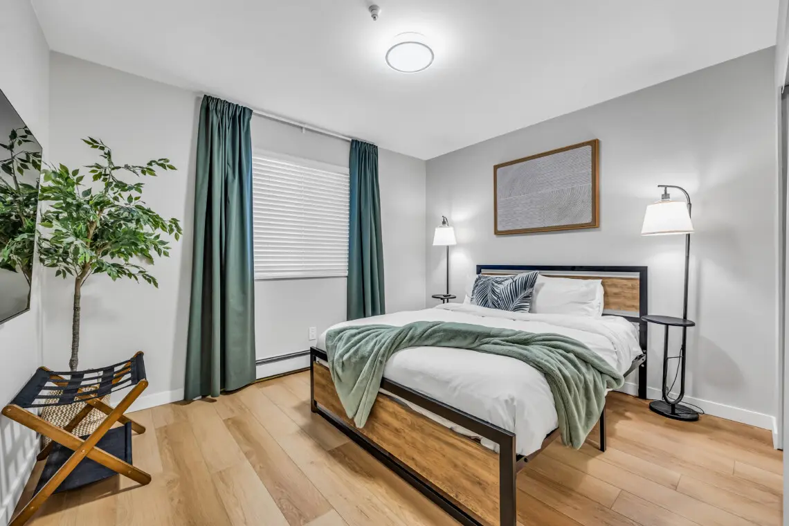 A cozy and modern bedroom designed for restful nights and laid-back evenings. Guests can unwind in comfort and enjoy a favorite show after a day exploring Vancouver.