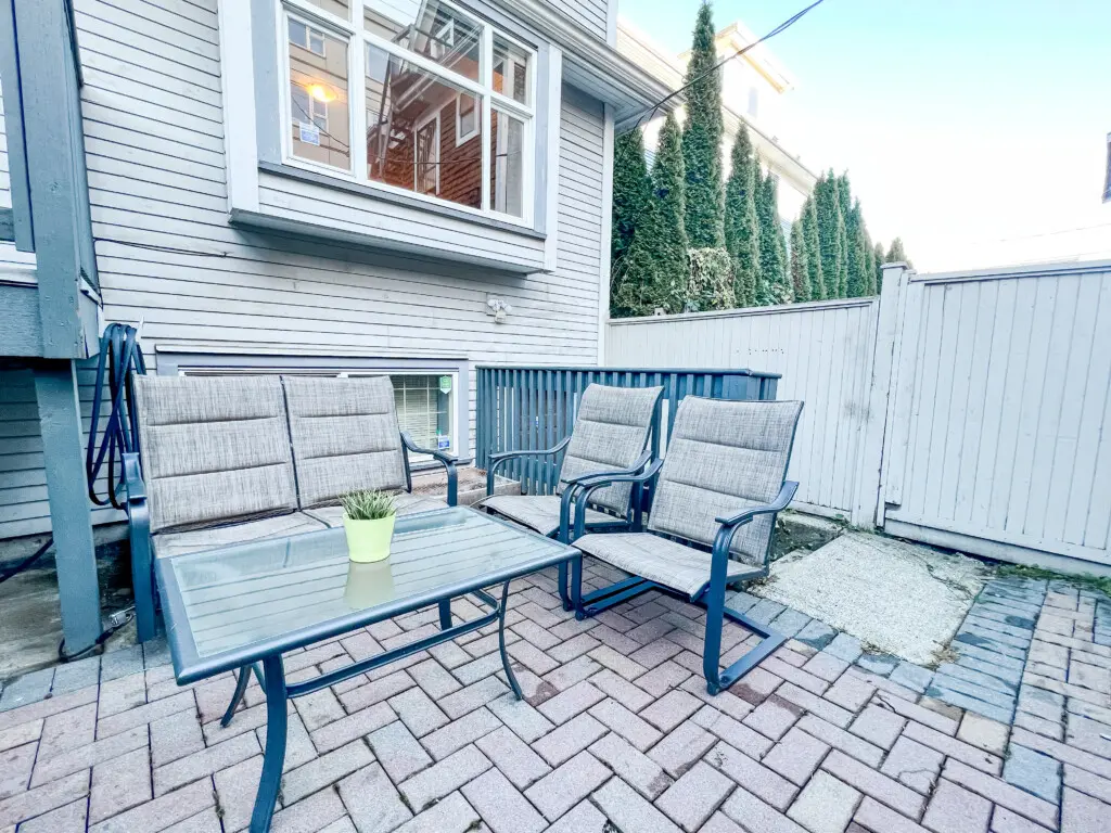 Relax outdoors in the private garden patio, featuring comfortable seating for four — perfect for morning coffee, evening chats, or enjoying fresh Vancouver air.
