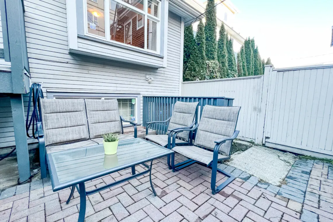 Relax outdoors in the private garden patio, featuring comfortable seating for four — perfect for morning coffee, evening chats, or enjoying fresh Vancouver air.