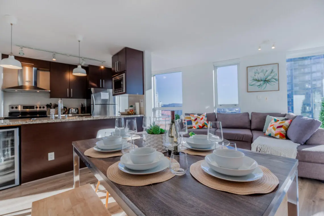 Experience the ease of open-concept living, where dining, cooking, and relaxation flow together in one beautifully designed space. Perfect for shared meals or cozy evenings in, this modern suite embodies the comfort and style of a true Vancouver stay.