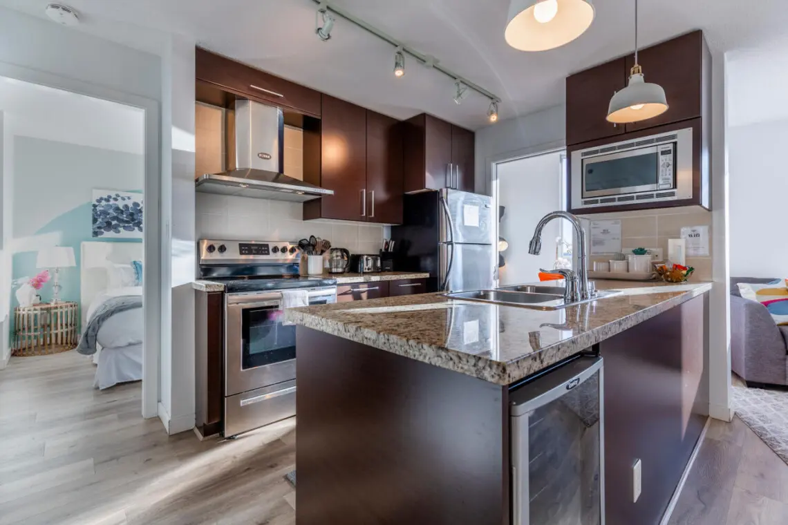 Enjoy stylish simplicity in this modern, fully equipped kitchen — complete with sleek finishes, stainless-steel appliances, and plenty of space to cook and connect. Perfect for preparing home-cooked meals during your Vancouver stay.