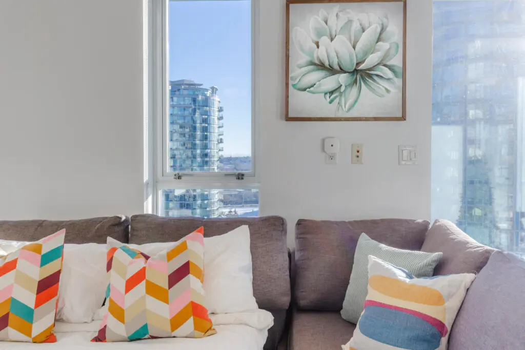 Modern comfort meets city charm in this cozy sofa nook, where guests can relax by the window and enjoy sweeping views of Vancouver’s skyline. A perfect spot to unwind and take in the urban scenery.