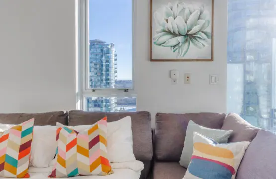 Modern comfort meets city charm in this cozy sofa nook, where guests can relax by the window and enjoy sweeping views of Vancouver’s skyline. A perfect spot to unwind and take in the urban scenery.