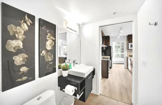 The second bathroom offers a bright and contemporary space, complete with elegant floral accents and modern fixtures. Thoughtfully designed for convenience and style, it connects seamlessly to the kitchen and living areas for effortless everyday comfort.