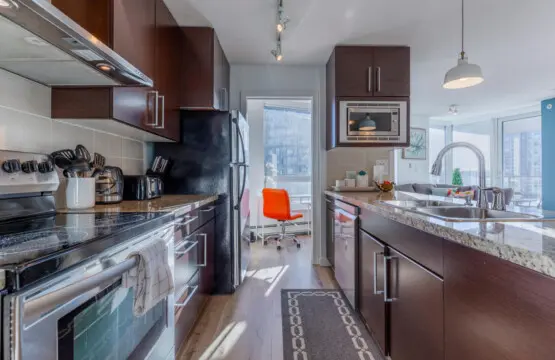 A chic culinary space where style meets functionality — this modern kitchen features stainless-steel appliances, granite countertops, and all the essentials for effortless home cooking during your Vancouver stay.