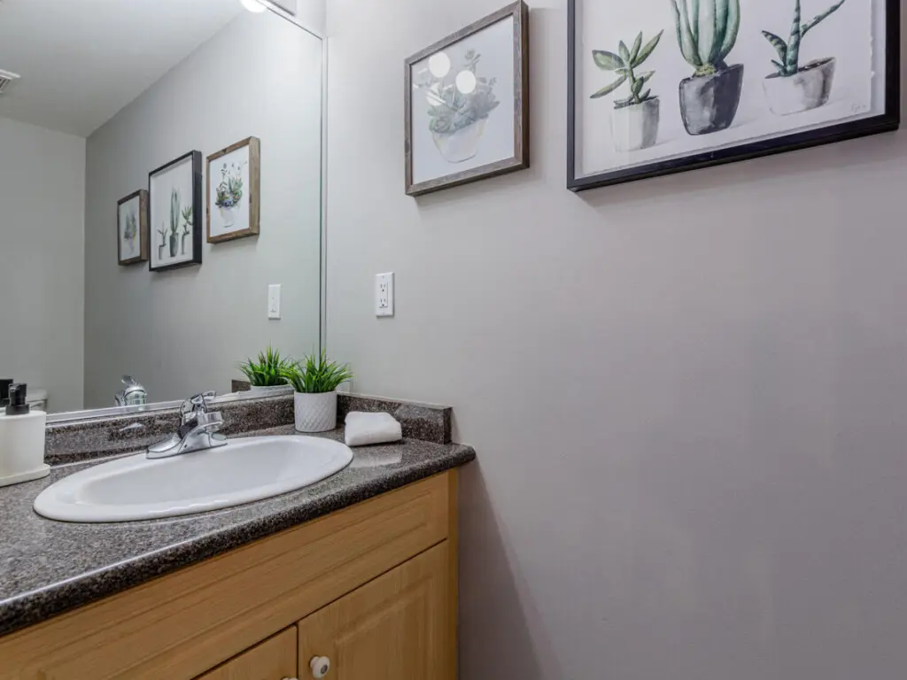 A convenient main-floor half bathroom featuring a modern vanity and fresh décor — perfect for quick refreshes during your Vancouver stay.