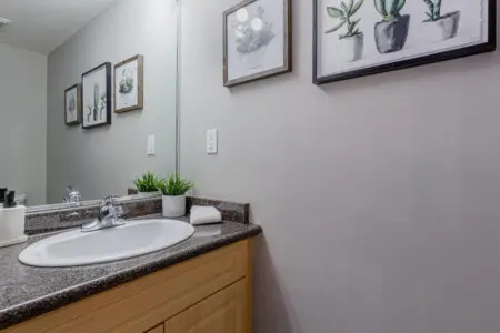 A convenient main-floor half bathroom featuring a modern vanity and fresh décor — perfect for quick refreshes during your Vancouver stay.