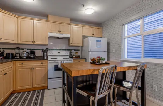 The spacious kitchen island offers a perfect spot to enjoy breakfast or a quick snack. Bright and fully equipped, this inviting space makes dining and meal prep feel effortless and homey.