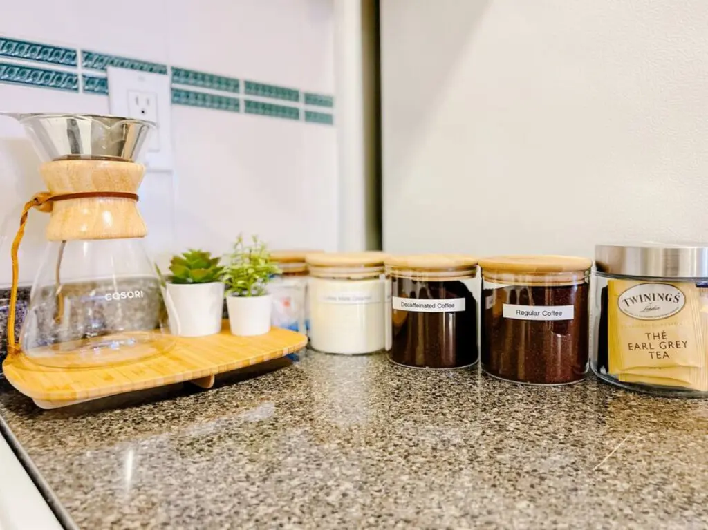 Enjoy complimentary coffee and tea at the cozy beverage station, complete with a pour-over coffee maker, regular and decaf options, sugars, and assorted teas — perfect for a relaxing start or end to your day.