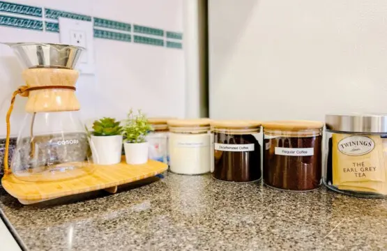 Enjoy complimentary coffee and tea at the cozy beverage station, complete with a pour-over coffee maker, regular and decaf options, sugars, and assorted teas — perfect for a relaxing start or end to your day.