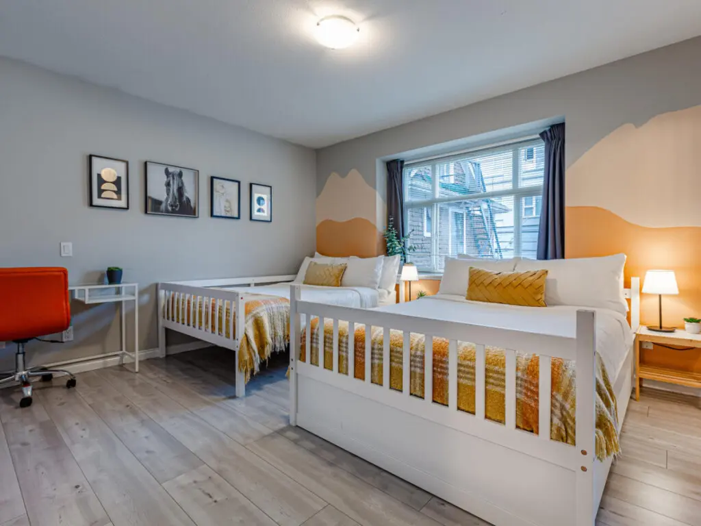 The second bedroom features two double beds and blackout curtains, offering a restful night’s sleep and a bright, cheerful space to start the day refreshed.