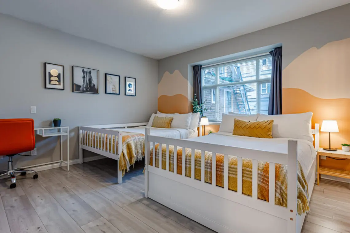 The second bedroom features two double beds and blackout curtains, offering a restful night’s sleep and a bright, cheerful space to start the day refreshed.