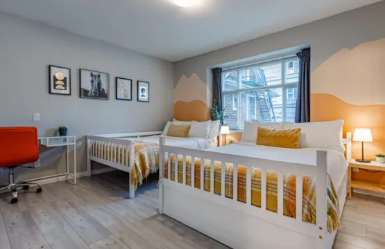 The second bedroom features two double beds and blackout curtains, offering a restful night’s sleep and a bright, cheerful space to start the day refreshed.