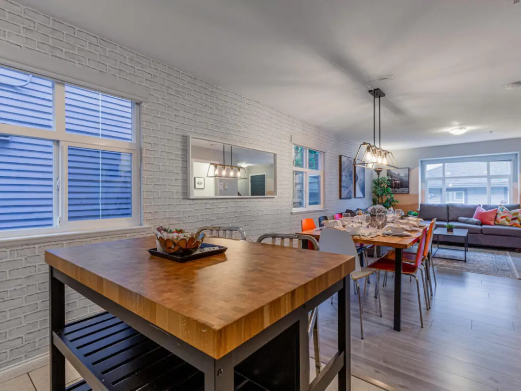 The kitchen island serves as both a cozy breakfast station and additional prep space, offering plenty of room for cooking, dining, or enjoying a relaxed morning coffee before heading out to explore the city.