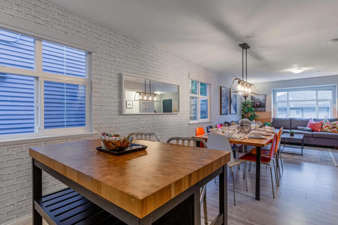 The kitchen island serves as both a cozy breakfast station and additional prep space, offering plenty of room for cooking, dining, or enjoying a relaxed morning coffee before heading out to explore the city.