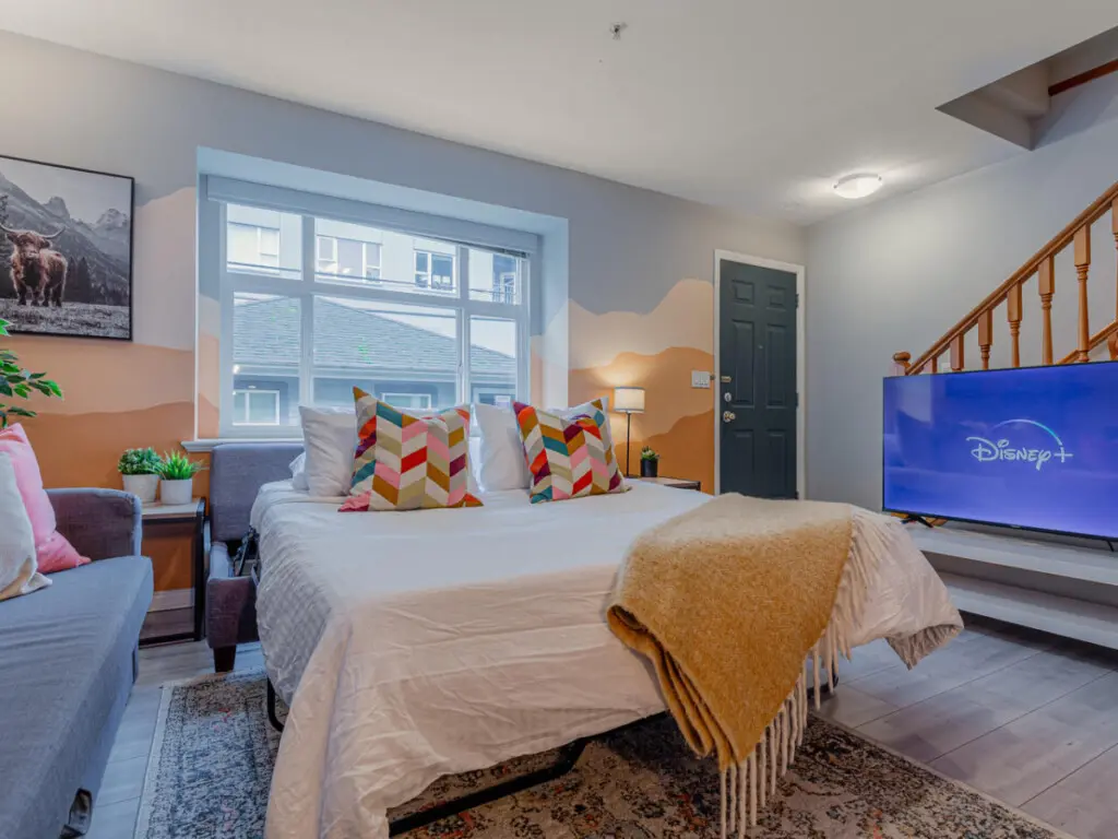 The cozy sofabed easily transforms into a comfortable sleeping space for two, perfect for extra guests or family members. A warm, welcoming setup that adds flexibility and comfort to your Vancouver stay.