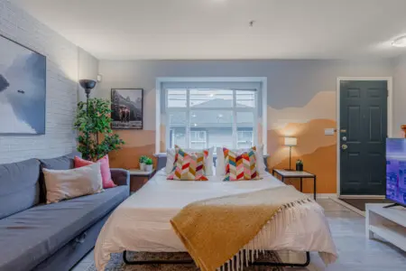 The living room sofa conveniently transforms into a comfortable pull-out bed, offering a relaxing place for up to two guests to rest. Perfect for families or groups needing extra sleeping space without sacrificing comfort or style.