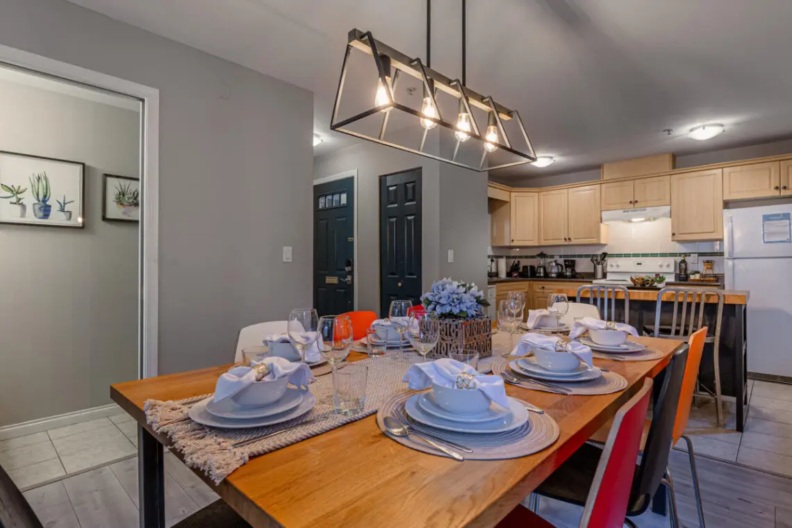 Gather around the spacious dining table for shared meals and conversation with family or friends. This welcoming space is perfect for entertaining and enjoying home-cooked dinners during your Vancouver stay.