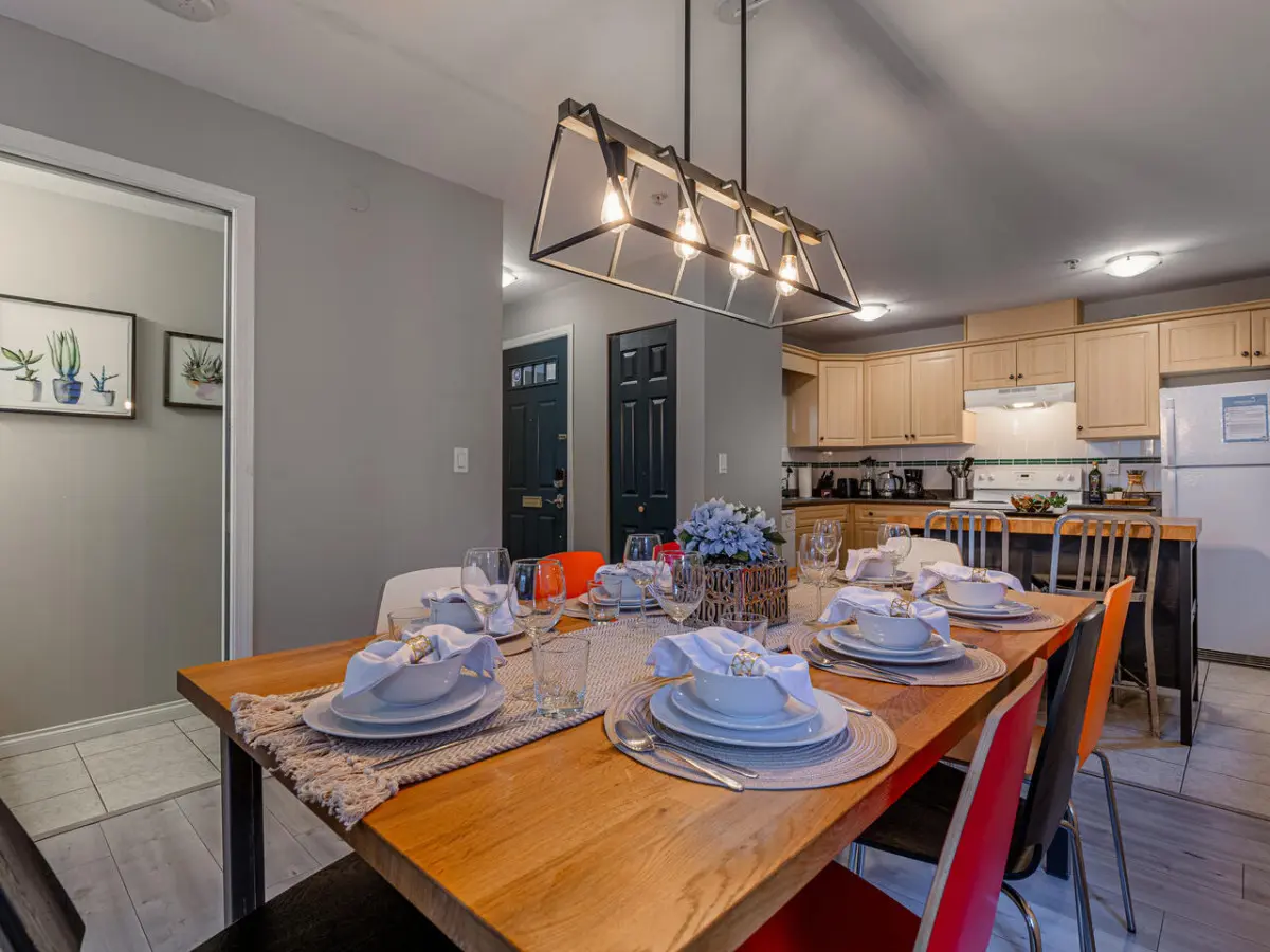 Gather around the spacious dining table for shared meals and conversation with family or friends. This welcoming space is perfect for entertaining and enjoying home-cooked dinners during your Vancouver stay.