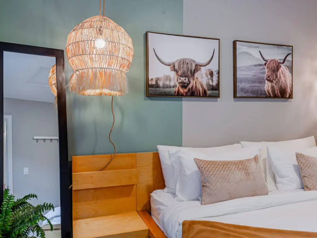 Settle into the cozy king bed after a day of city adventures, surrounded by soft lighting and natural textures that create a peaceful, restful ambiance.