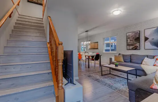 The staircase leads from the open living area to the private upstairs bedrooms, seamlessly connecting shared spaces with restful retreats.