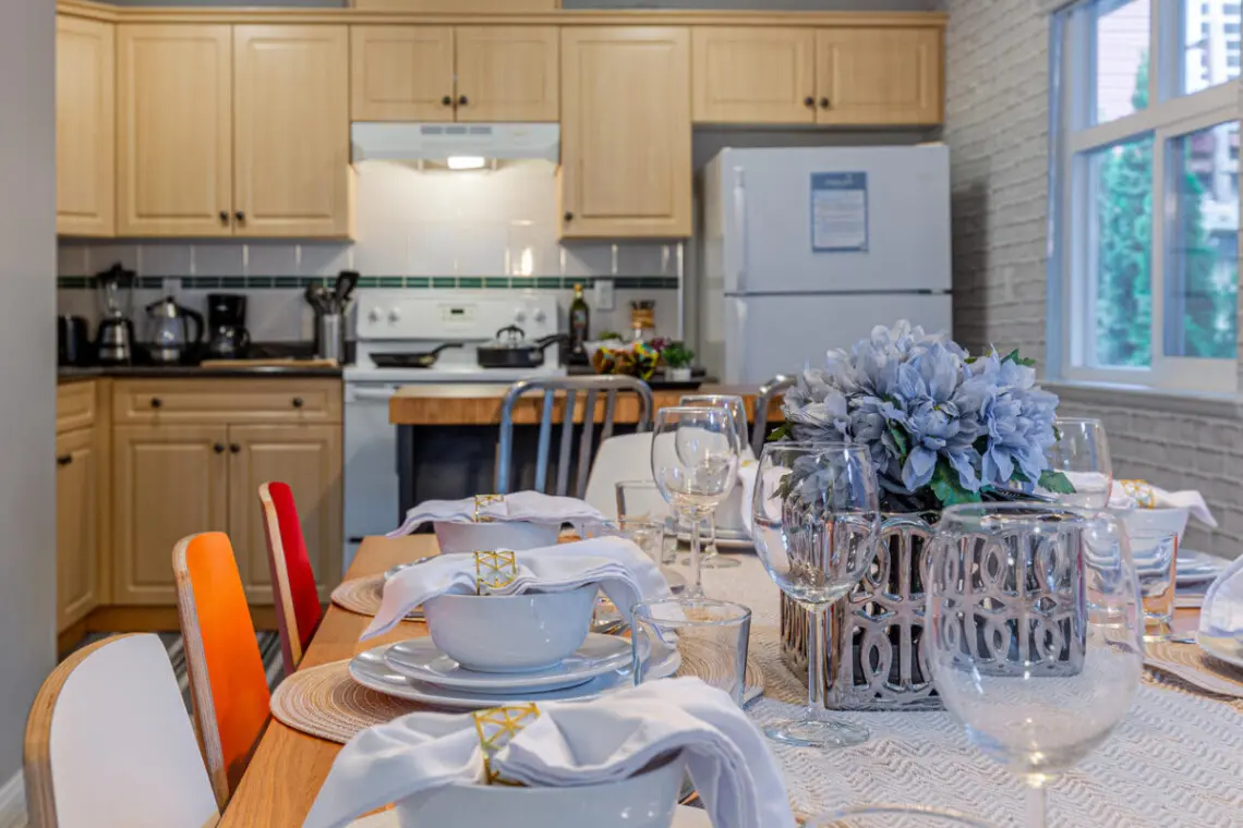 Enjoy effortless cooking and conversation in this open kitchen and dining area, designed for connection and comfort. A warm, social space where shared meals and memorable moments enhance your Vancouver stay.
