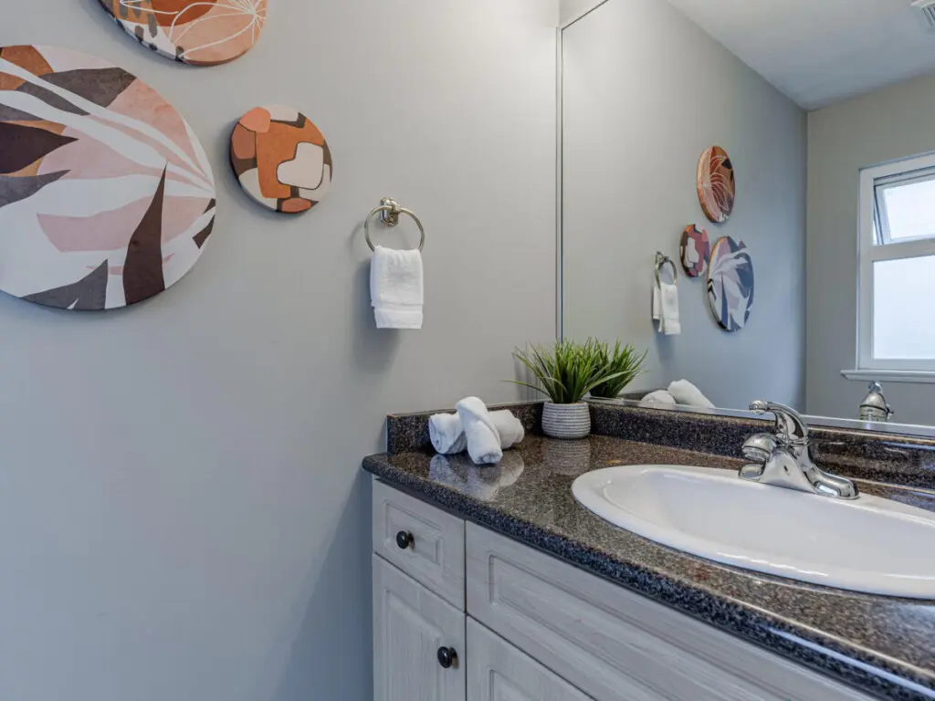 The second-floor ensuite half bathroom, located off the guest bedroom, offers modern finishes and simple elegance — a convenient addition for extra comfort and privacy.