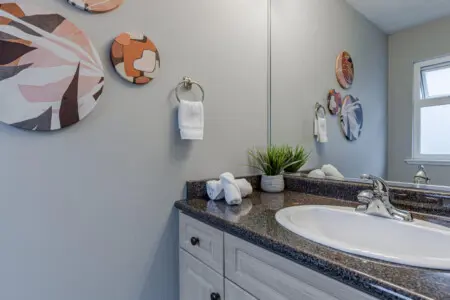 The second-floor ensuite half bathroom, located off the guest bedroom, offers modern finishes and simple elegance — a convenient addition for extra comfort and privacy.