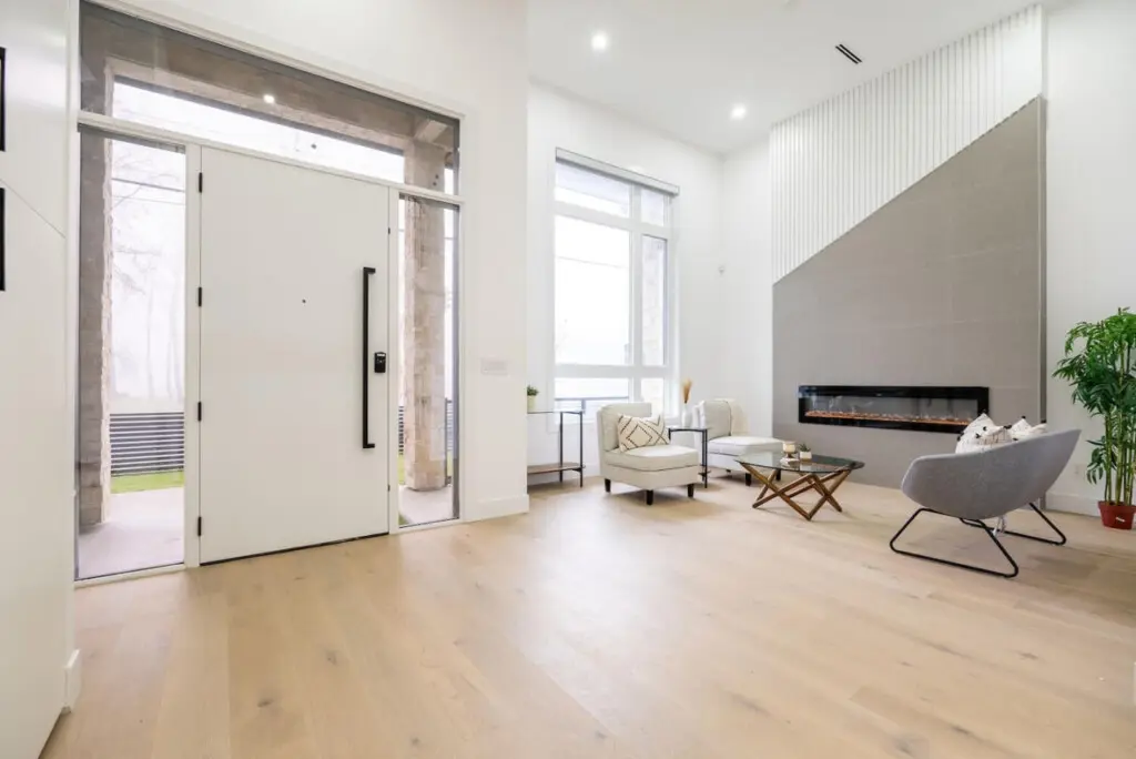 Guests are welcomed by a bright, open foyer that flows into a cozy sitting area complete with a sleek indoor fireplace — a perfect blend of modern elegance and inviting warmth for your Vancouver stay.