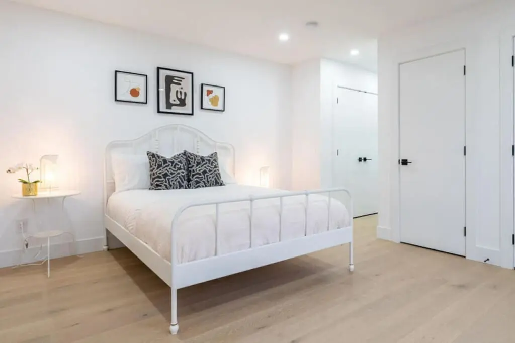 This serene third bedroom features a plush queen bed, soft lighting, and minimalist décor that invites total relaxation. With its bright, airy ambiance and modern finishes, it offers guests a peaceful retreat to unwind and recharge during their Vancouver