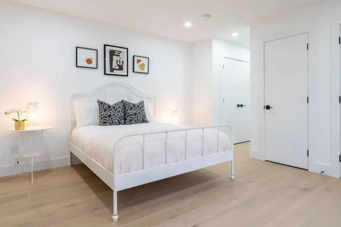 This serene third bedroom features a plush queen bed, soft lighting, and minimalist décor that invites total relaxation. With its bright, airy ambiance and modern finishes, it offers guests a peaceful retreat to unwind and recharge during their Vancouver