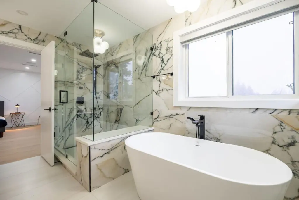Ensuite Bathroom (Connected to Primary Bedroom 1): Indulge in the spa-inspired ensuite featuring a freestanding tub and glass-enclosed shower. A serene retreat designed for ultimate relaxation and privacy during your stay.