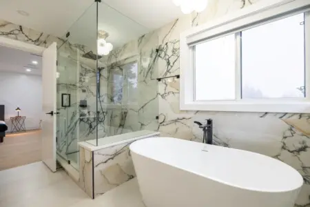 Ensuite Bathroom (Connected to Primary Bedroom 1): Indulge in the spa-inspired ensuite featuring a freestanding tub and glass-enclosed shower. A serene retreat designed for ultimate relaxation and privacy during your stay.