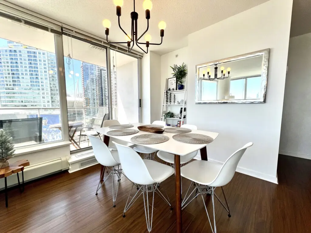 Enjoy bright and airy dining with floor-to-ceiling windows framing stunning city views. The elegant dining area opens onto a private balcony — perfect for leisurely meals and relaxed moments overlooking False Creek.