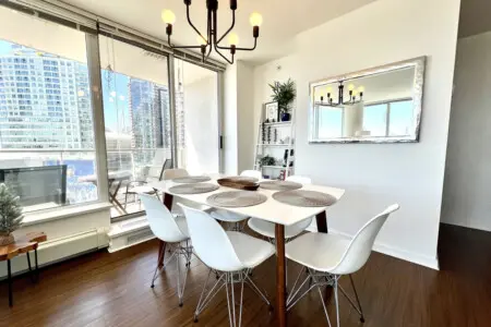 Enjoy bright and airy dining with floor-to-ceiling windows framing stunning city views. The elegant dining area opens onto a private balcony — perfect for leisurely meals and relaxed moments overlooking False Creek.