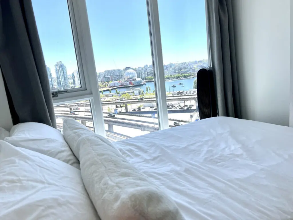 Wake up to breathtaking city and waterfront views from this bright bedroom — a peaceful spot to start and end your day in modern Vancouver comfort.