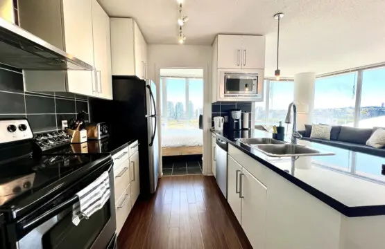 Prepare and share meals with ease in this sleek, open-concept kitchen — featuring modern appliances, spacious countertops, and bright city views that inspire connection.