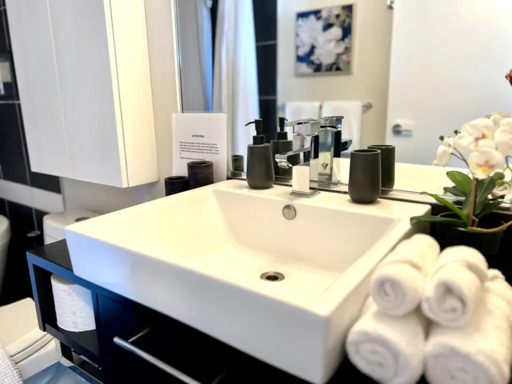 Experience everyday luxury in this modern bathroom, where sleek finishes, soft towels, and elegant details create a serene start or end to your day during your Vancouver stay.