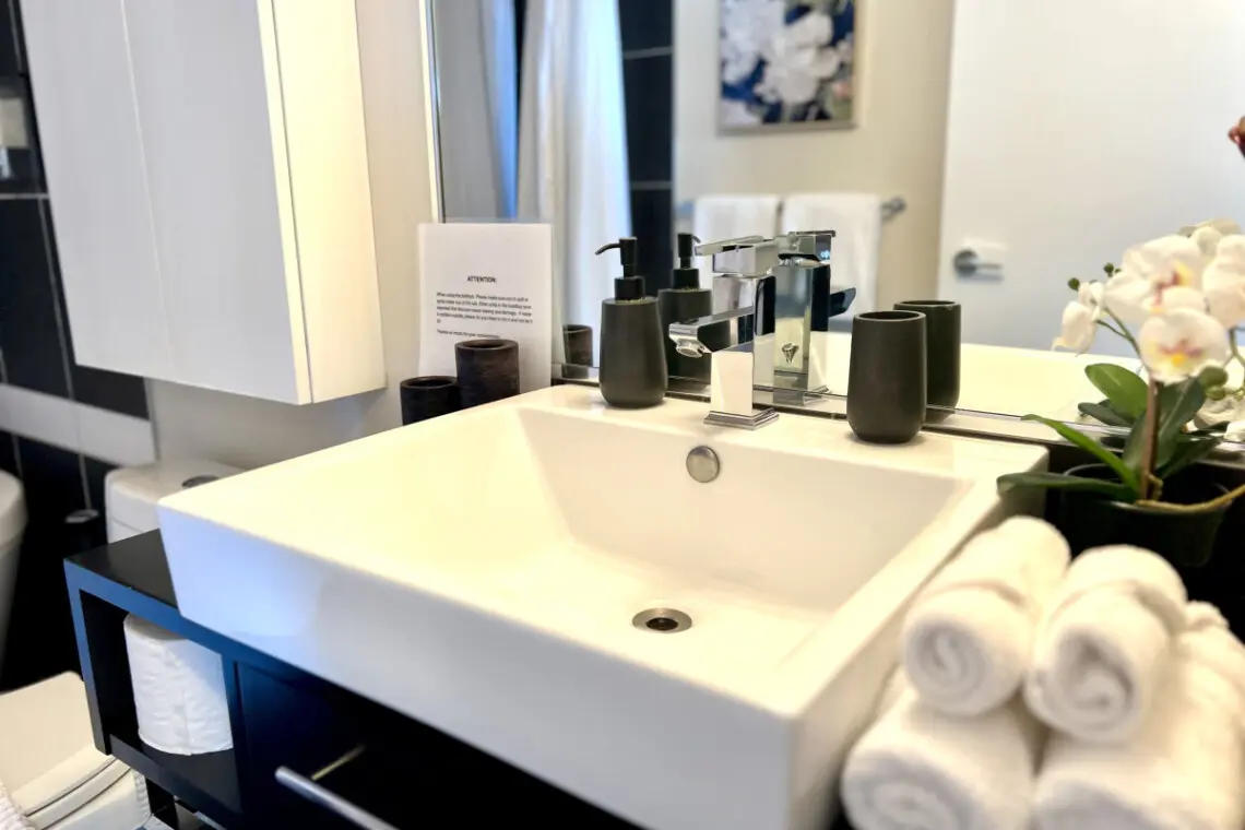 Experience everyday luxury in this modern bathroom, where sleek finishes, soft towels, and elegant details create a serene start or end to your day during your Vancouver stay.