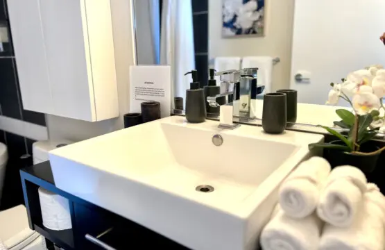 Experience everyday luxury in this modern bathroom, where sleek finishes, soft towels, and elegant details create a serene start or end to your day during your Vancouver stay.