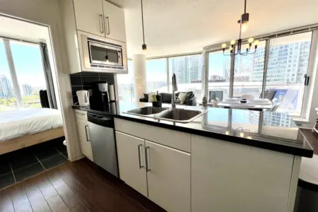 Enjoy cooking and conversation in this bright, open-concept kitchen. Featuring modern appliances, sleek countertops, and stunning city views — it’s the perfect space to prepare meals and connect with loved ones.
