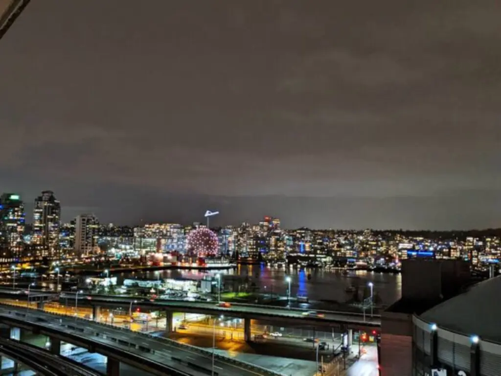 Take in the dazzling night skyline of Vancouver, where city lights reflect over the water — a breathtaking view right from your furnished suite.