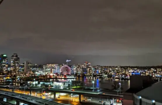 Take in the dazzling night skyline of Vancouver, where city lights reflect over the water — a breathtaking view right from your furnished suite.