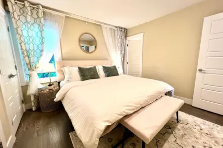 Unwind in this elegant bedroom featuring a plush king-size bed, soft lighting, and refined décor — designed to offer the perfect night’s rest in comfort and style.