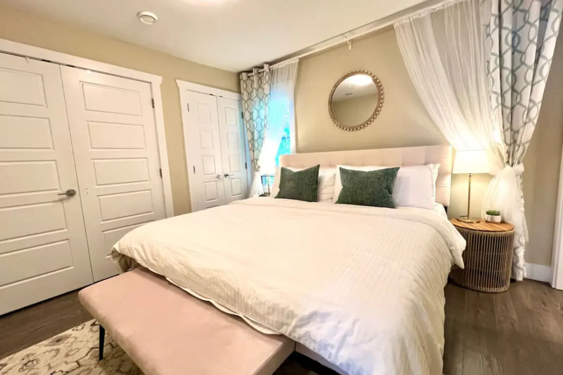 Spacious and serene, this inviting bedroom features a luxurious king-sized bed, elegant decor, and soft lighting for the perfect retreat.