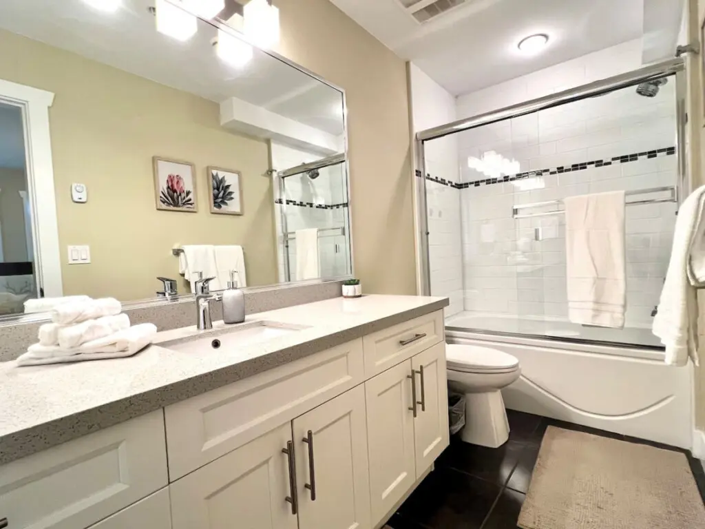 Bright and well-appointed, this second-floor bathroom features modern fixtures, fresh towels, and a spacious vanity for added comfort and convenience.