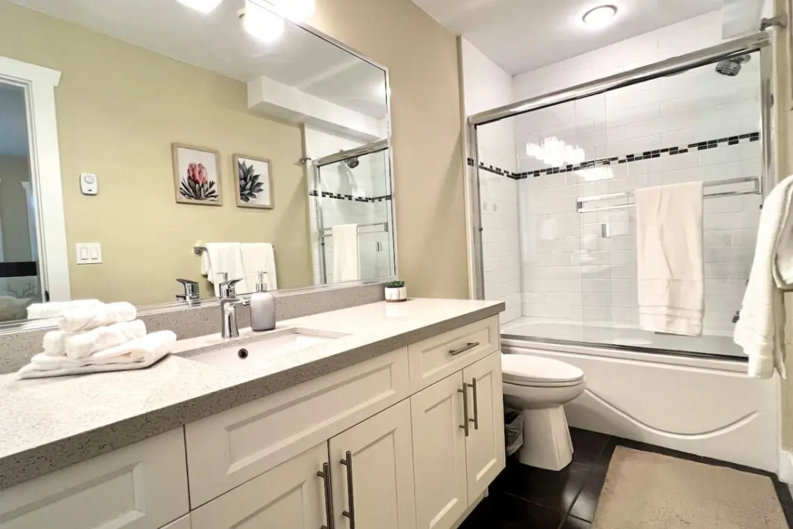 Bright and well-appointed, this second-floor bathroom features modern fixtures, fresh towels, and a spacious vanity for added comfort and convenience.