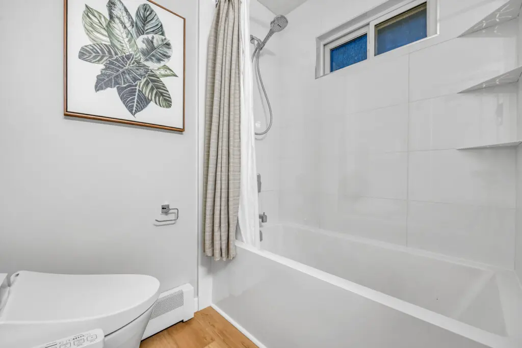 A cozy bathroom retreat where self-care meets serenity — complete with warm tones, soft lighting, and thoughtful modern touches that invite guests to unwind and enjoy a little everyday luxury during their stay.